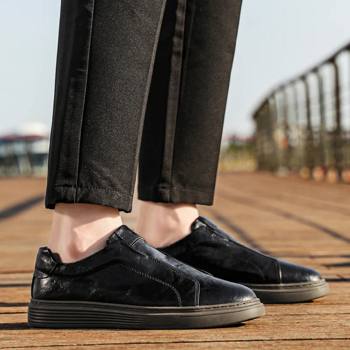 Alvio genuine leather slip-on shoes showcasing smooth black leather and cushioned soles for comfort and style.