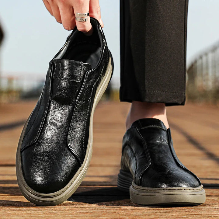 Alvio genuine leather slip-on shoes, featuring a smooth black finish and cushioned footbed for comfort and style.