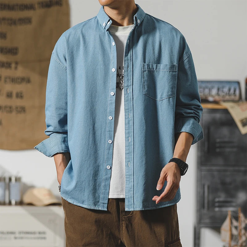 Frontier Denim Jacket worn by a model, featuring a minimalist design and subtle distressing for everyday wear.