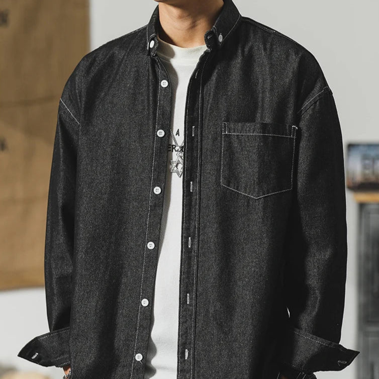 Frontier Denim Jacket showcasing a stylish minimal design and subtle distressing in dark denim fabric.