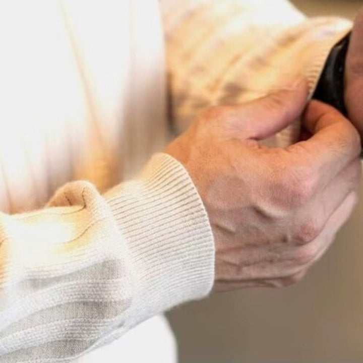 Close-up of a hand adjusting a watch while wearing a ribbed Jay Flex-Fit Shirt with a structured collar.