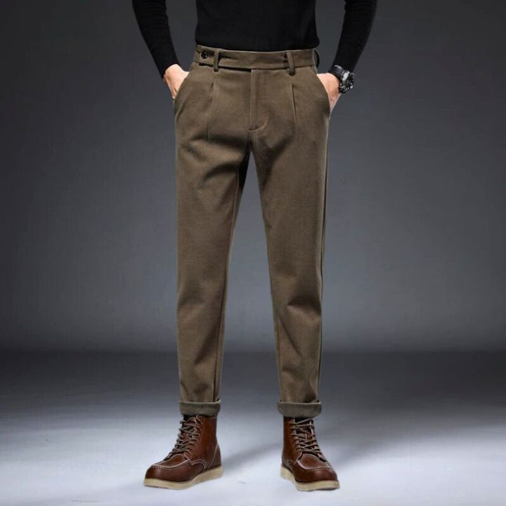 Hudson tailored trousers in brown with a refined fit, stylishly paired with leather boots, showcasing a polished look.