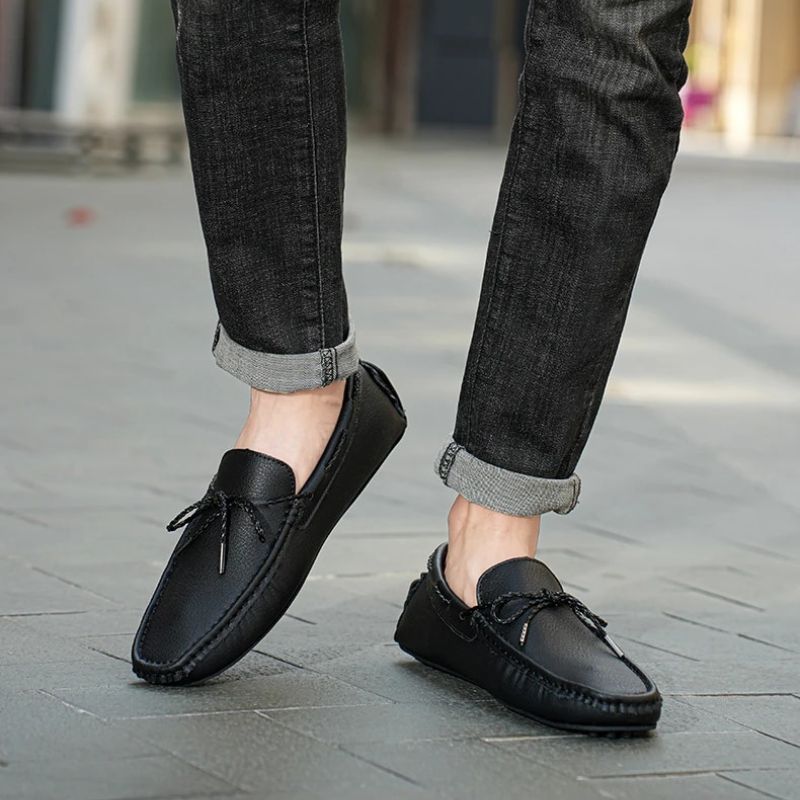 Kingsley Genuine Leather Loafers in black, stylishly worn with rolled jeans for a casual look.