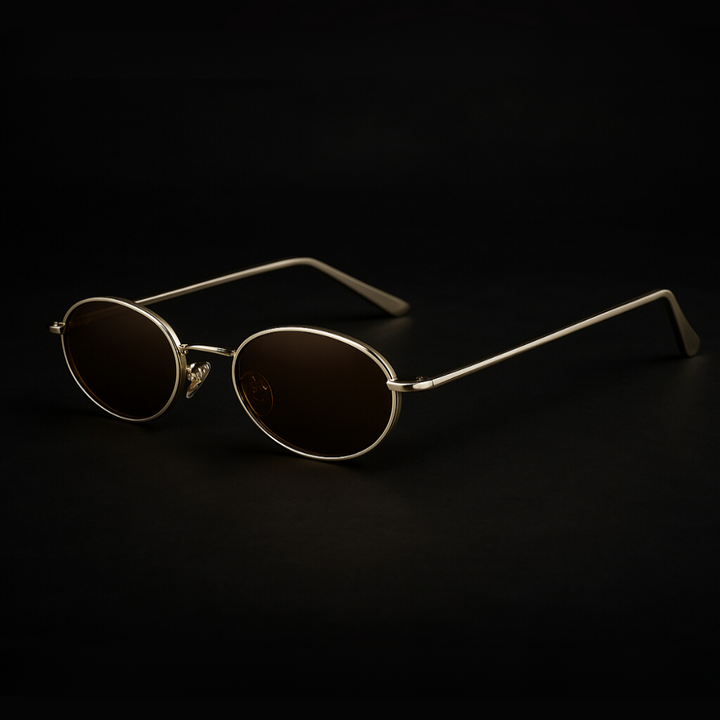 Orin Oval Frame Sunglasses with polished metallic finish and dark lenses; stylish, durable, and comfortable with UV400 protection.