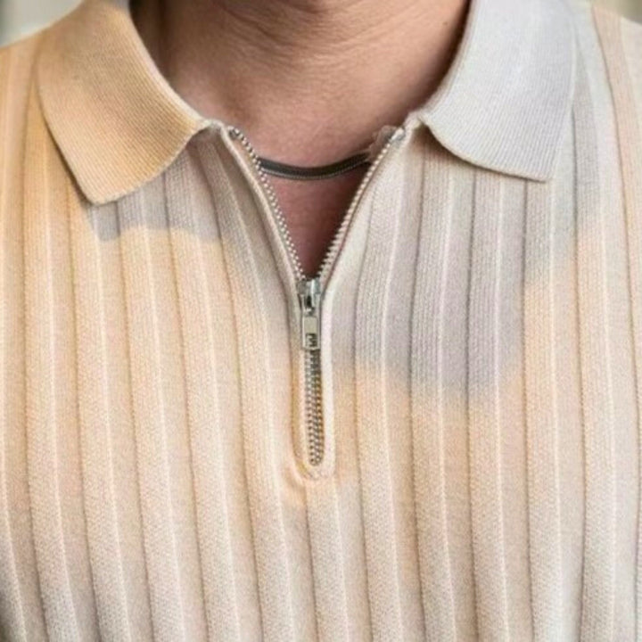 Close-up of a ribbed zip polo shirt featuring a structured collar and quarter-zip detail, showcasing an athletic fit.