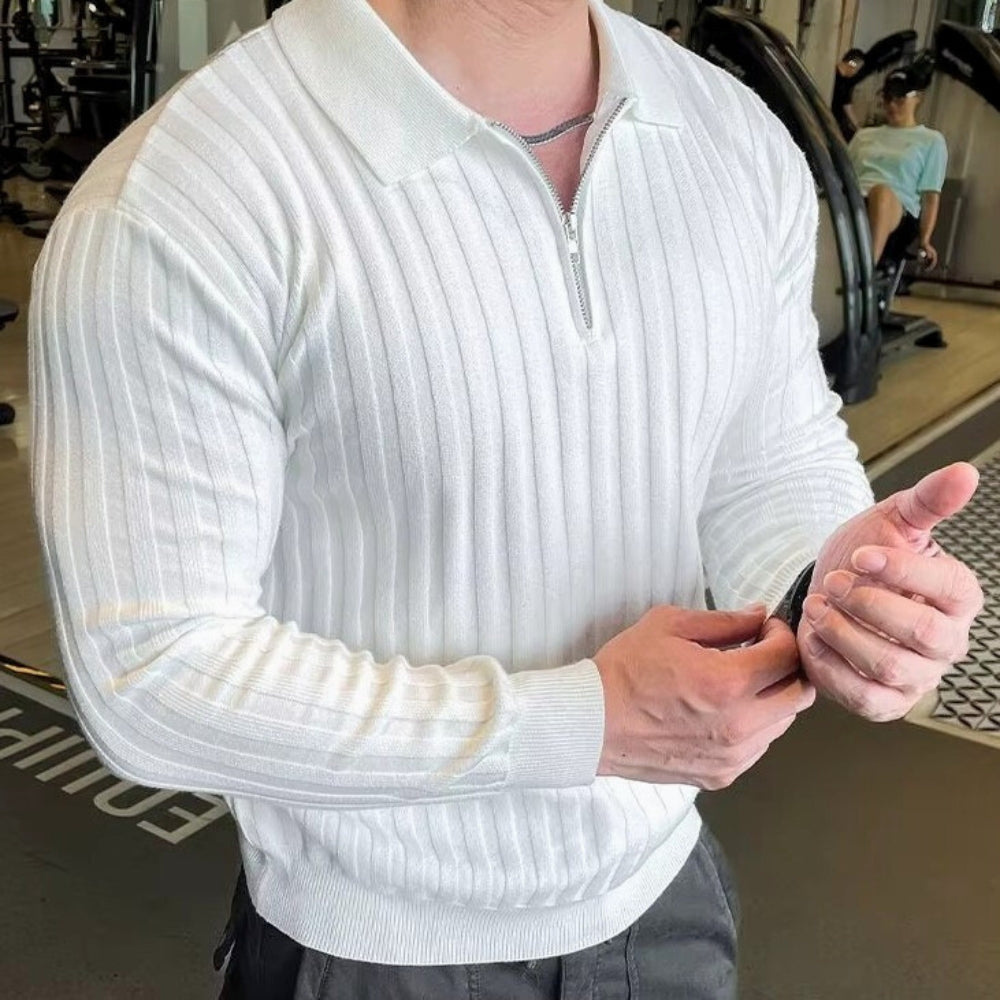 Man wearing a white Jay Flex-Fit shirt with ribbed texture and quarter-zip detail in a gym setting.