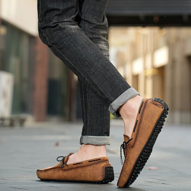 Man wearing Kingsley genuine leather loafers in brown, showcasing breathable construction and non-slip outsole.