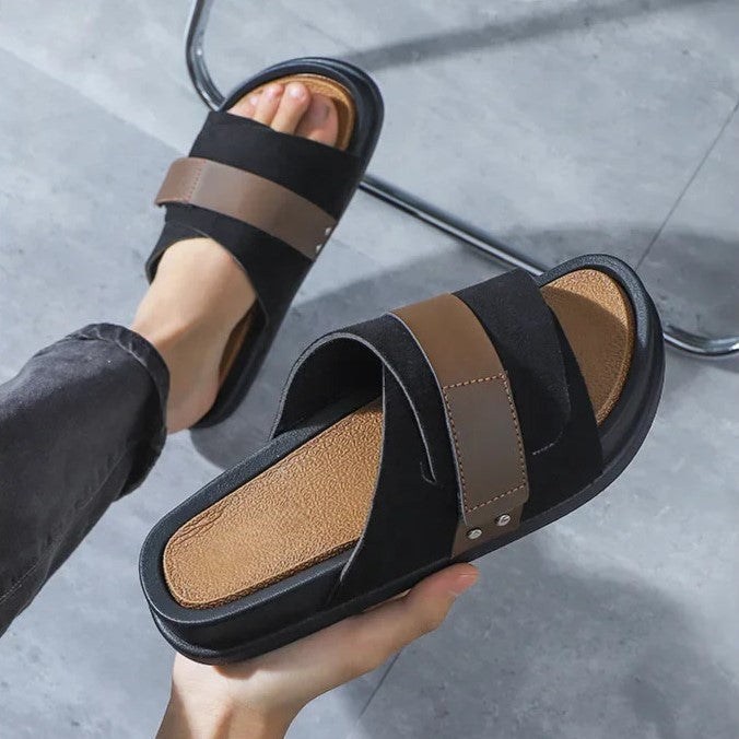 Mojave Men's Suede Slides in black with brown leather accents, showcasing a thick sole for comfort and durability.