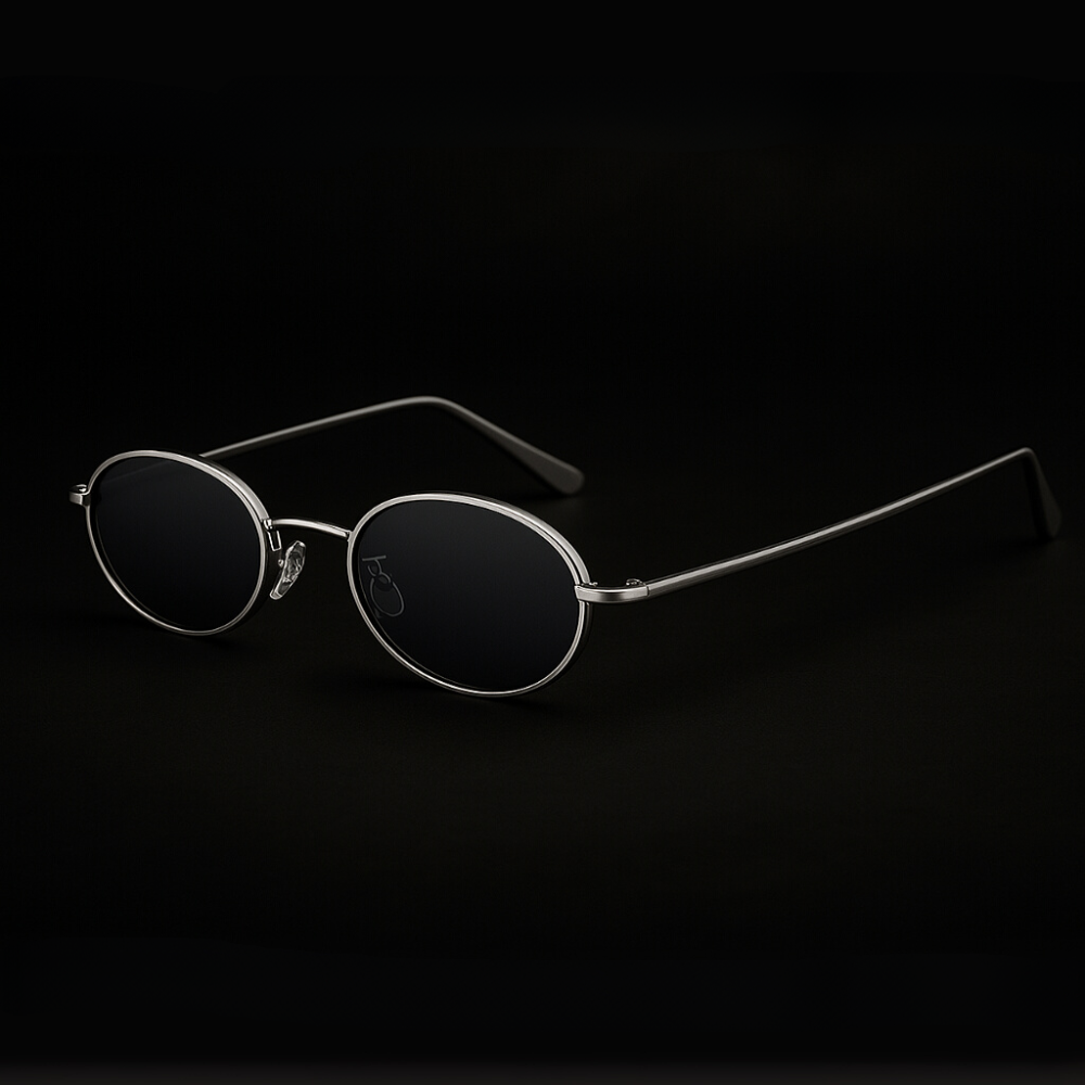 Orin oval frame sunglasses with polished metallic finish and black lenses, offering UV protection and ergonomic comfort.