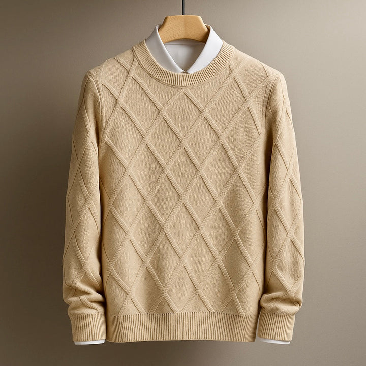 Beige sweater with diamond pattern on a hanger against a brown background