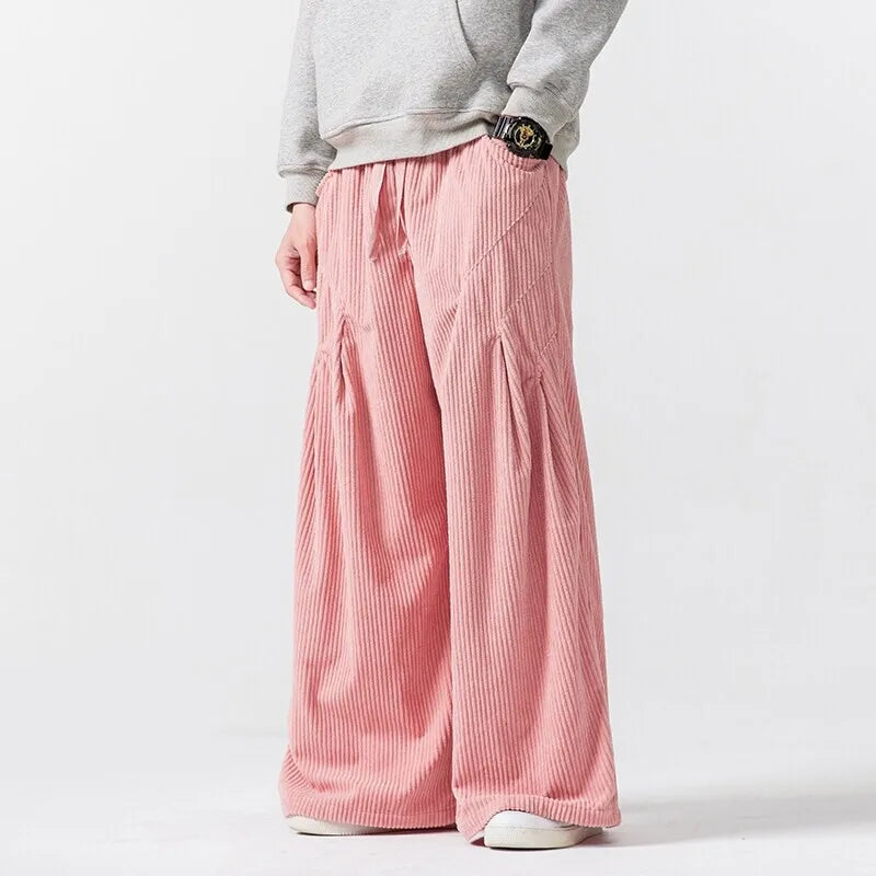 Hollis Corduroy Pants in pink, featuring wide-leg design, deep pleats, and comfortable elastic waistband for effortless style.