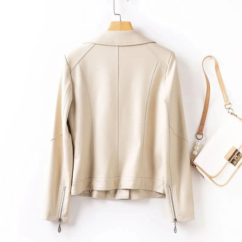 Beige leather jacket on a hanger with a handbag in the background