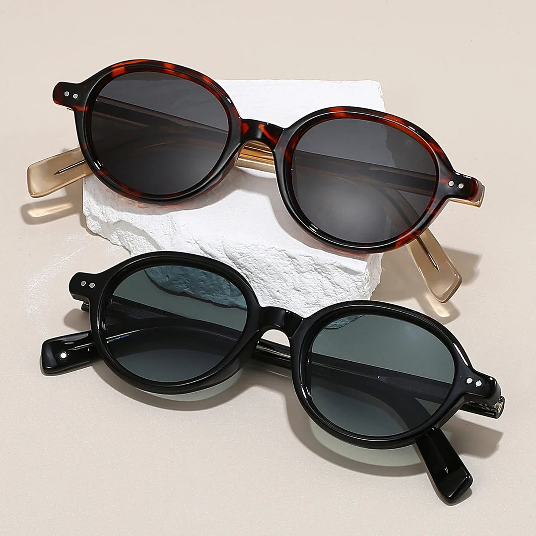 Sable Round Sunglasses in tortoiseshell and black frames with UV-blocking tinted lenses, showcasing bold design and ergonomic comfort.
