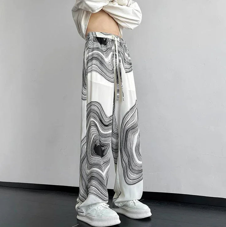 Vortex Ripple Pants featuring wide-leg design, abstract print, and adjustable drawstring waist for effortless style.