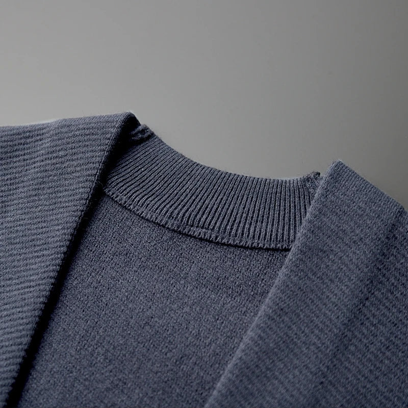 Close-up view of a gray Rowan Merino cardigan featuring a ribbed collar and soft fabric texture.