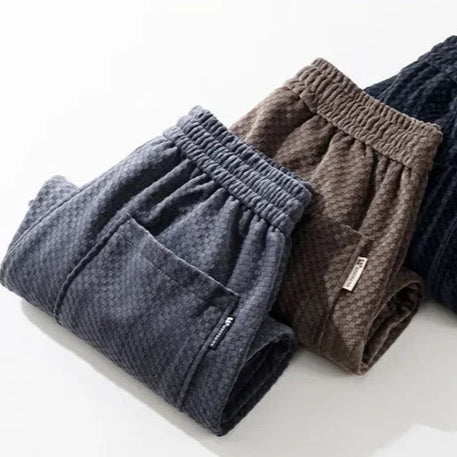 Riden Checkered Corduroy Pants in navy and brown with tapered fit and soft textured fabric.