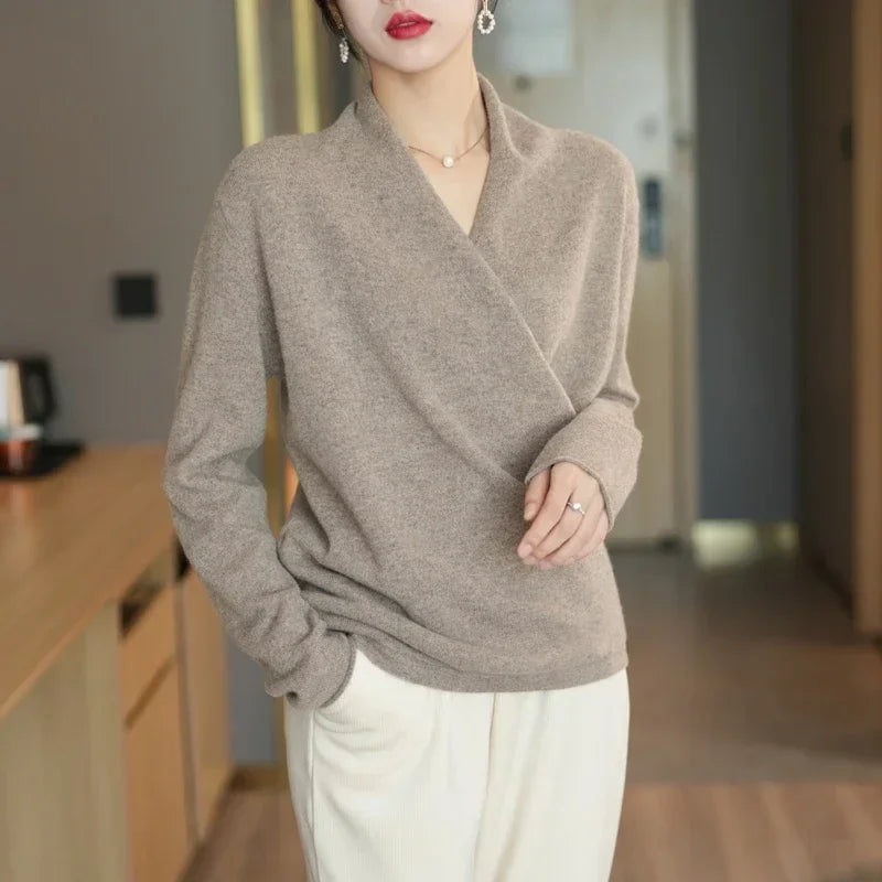 Crossover wool sweater in neutral beige, featuring a wrap-front design for elegant and relaxed comfort.