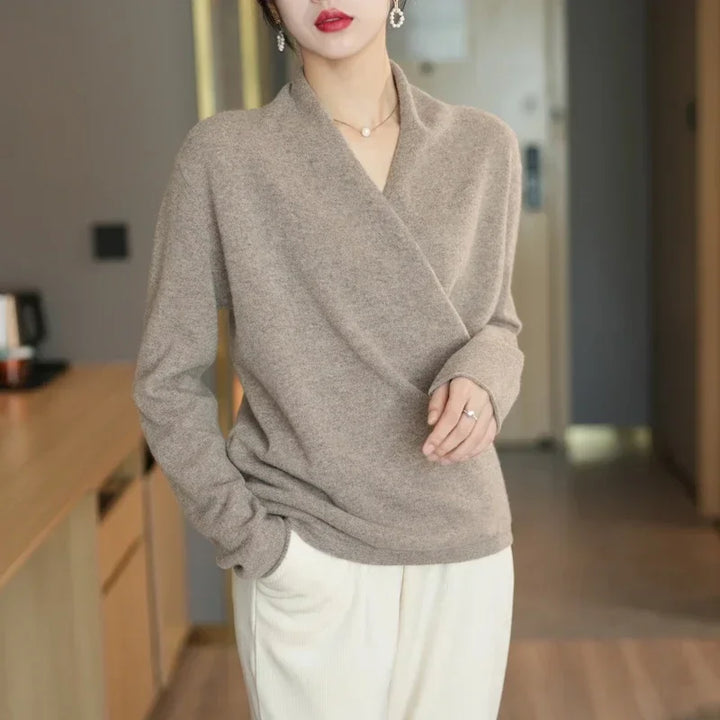 Crossover wool sweater in neutral beige, featuring a wrap-front design for elegant and relaxed comfort.