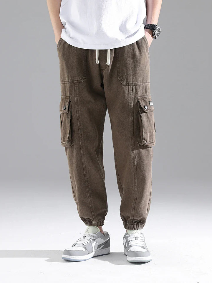 Lennox Cargo Joggers in brown, featuring oversized pockets, gathered cuffs, and a relaxed tapered fit.