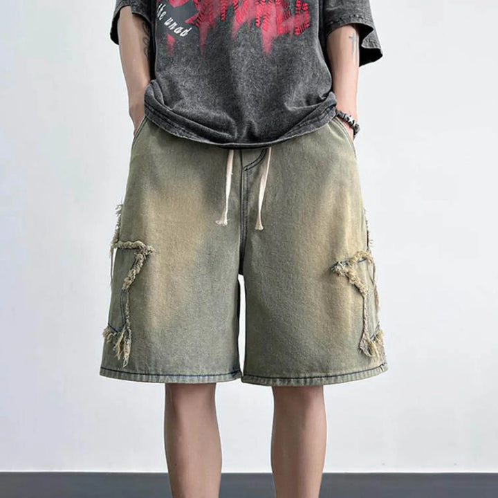 Sidestar washed denim shorts with raw-edged star patches and drawstring waist for relaxed skater fit.