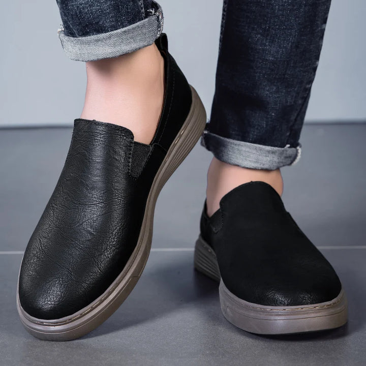 Duke Leather Slip-On Shoes in black, featuring elastic side panels and a cushioned sole for comfort and style.
