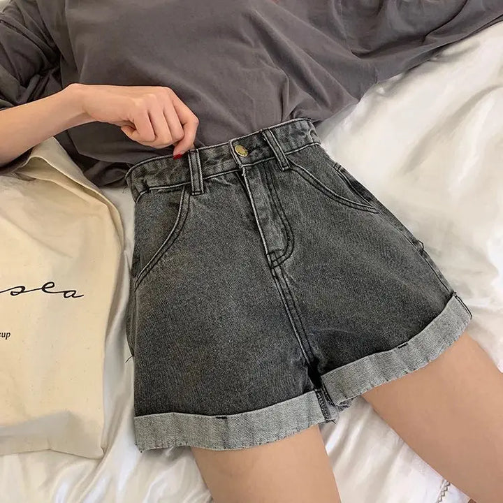 High-waisted Sienna retro denim shorts with cuffed hems and vintage stitching in gray, styled on a model.