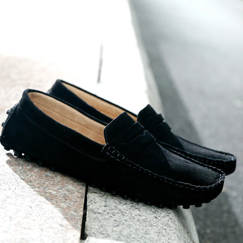 Grazia Suede Loafers in black with precision hand-stitching and textured rubber sole for effortless style.