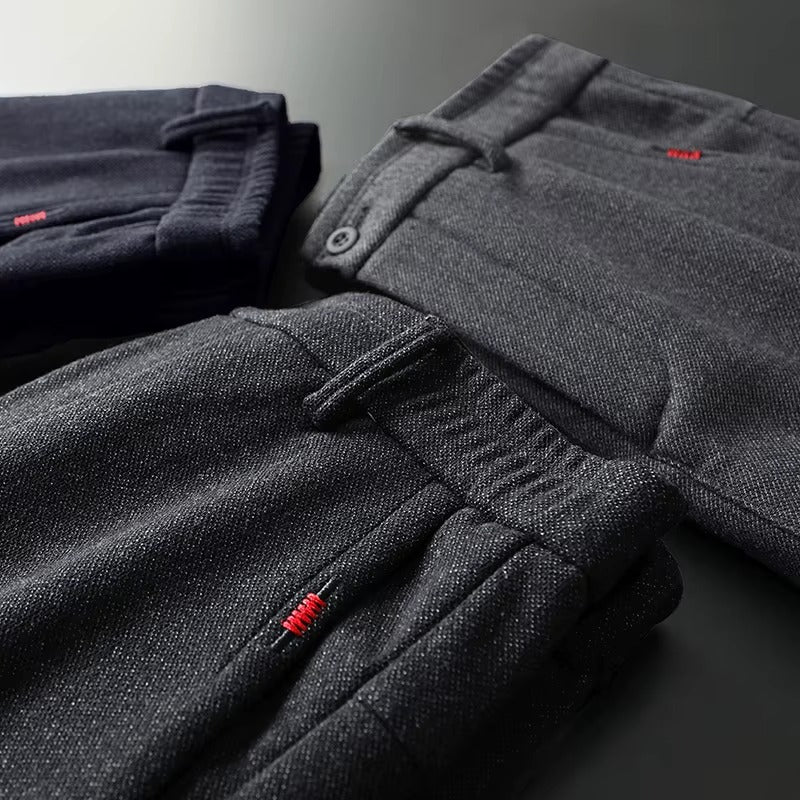 Henderson Slim-Fit Pants in dark colors folded, showcasing modern design and soft cotton-bamboo blend fabric.