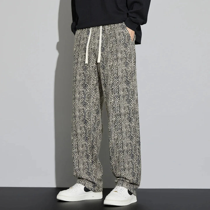 Lennox cotton linen pants featuring adjustable drawstring, breathable fabric, and woven herringbone texture, styled with white sneakers.