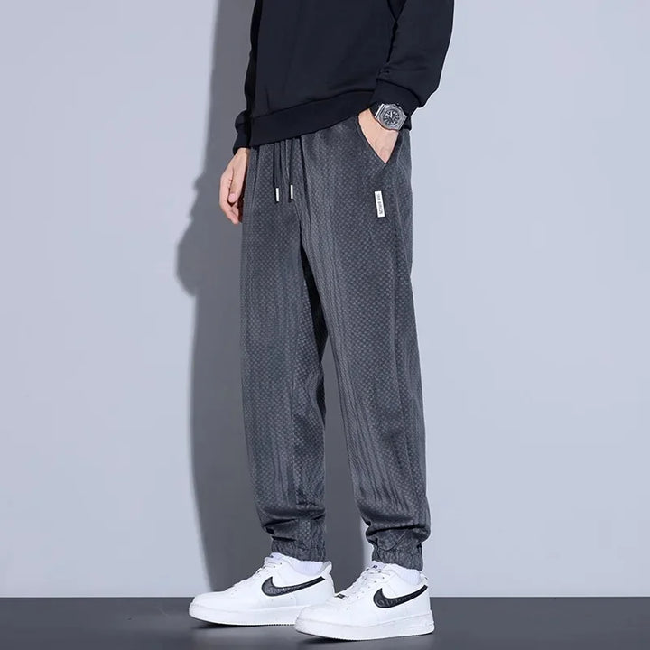 Men's tapered checkered corduroy pants in gray, featuring a soft brushed interior and adjustable waistband for comfort.
