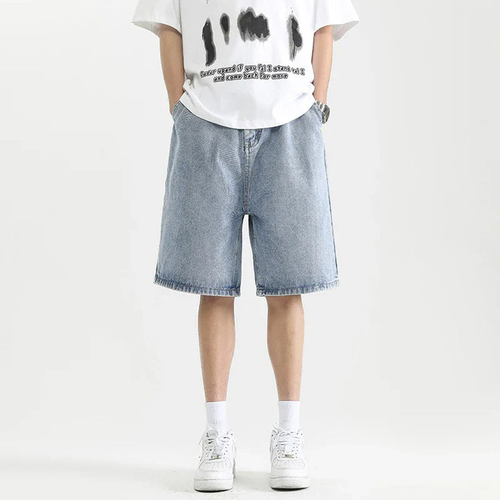 Lennox Men's Relaxed Denim Shorts in light blue with a casual fit, paired with a graphic t-shirt and white sneakers.