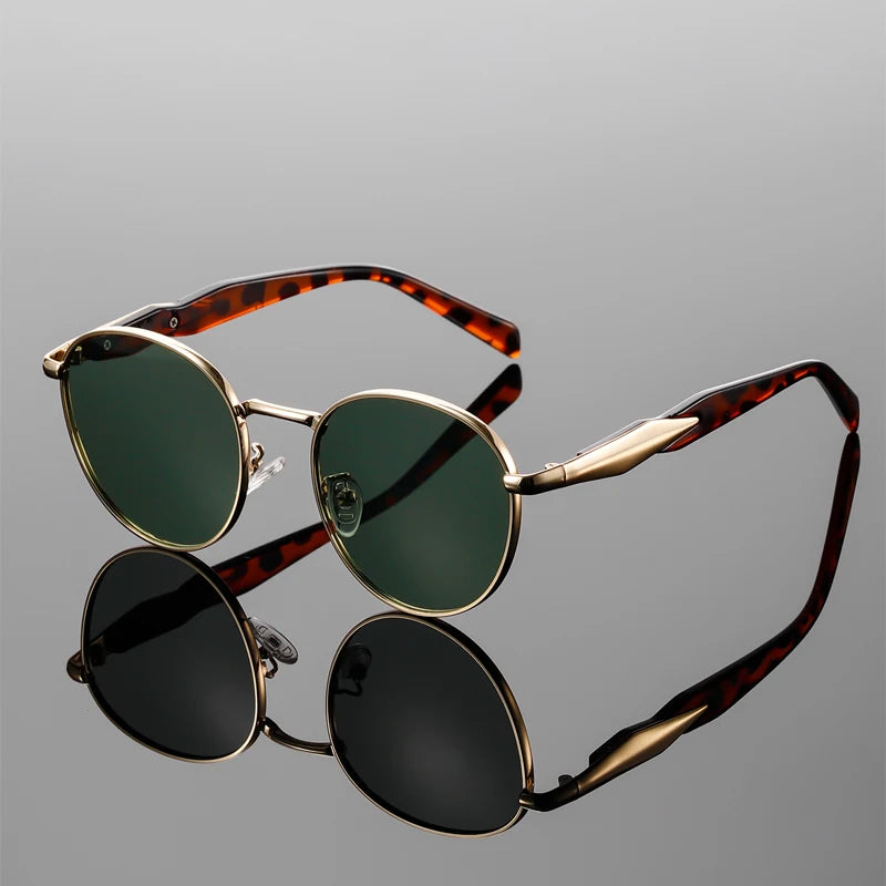 Bold round-frame Bellano sunglasses with tortoiseshell arms and green UV-protective lenses against a sleek background.