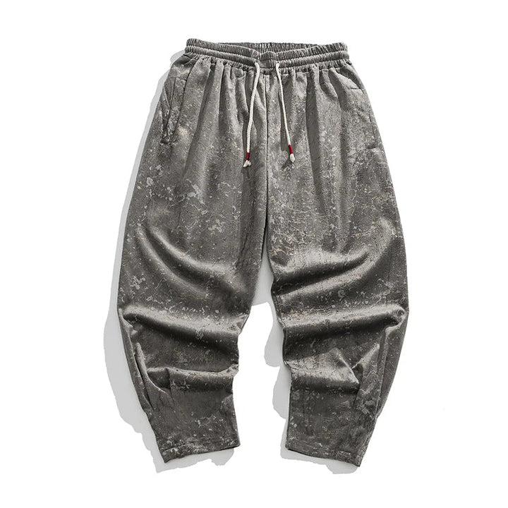 Soft crushed velvet joggers with elastic cuffs and drawstring waist in gray, showcasing a relaxed fit and stylish sheen.