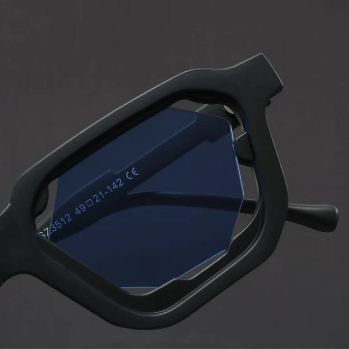 Vantor Sunglasses featuring a sharp geometric frame and blue lenses, highlighting bold sculpted edges and ergonomic design.