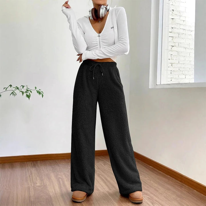 Young woman wearing Sherpa Flow Sweatpants with a relaxed fit and adjustable drawstring, styled for comfort and casual outings.