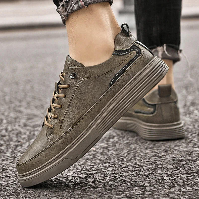 Genesis Leather Sneakers in grey with lace-up design, cushioned interior, and durable rubber sole for style and comfort.