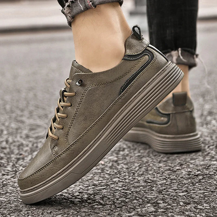 Genesis Leather Sneakers in grey with lace-up design, cushioned interior, and durable rubber sole for style and comfort.