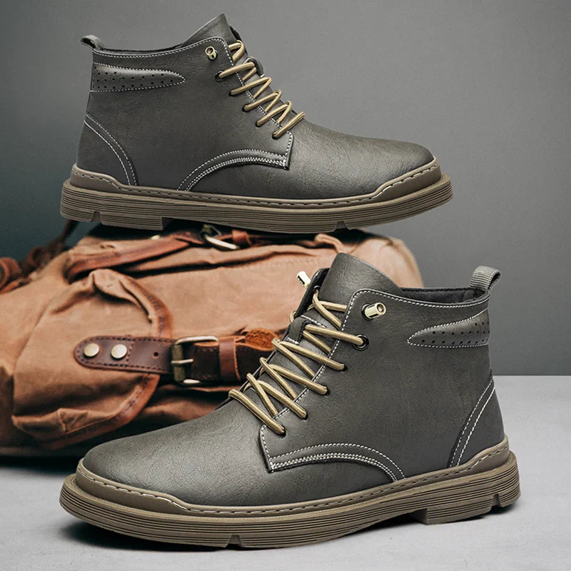 Wayfarer genuine leather hi-tops in grey with lace-up design and rugged sole, paired with a canvas bag.