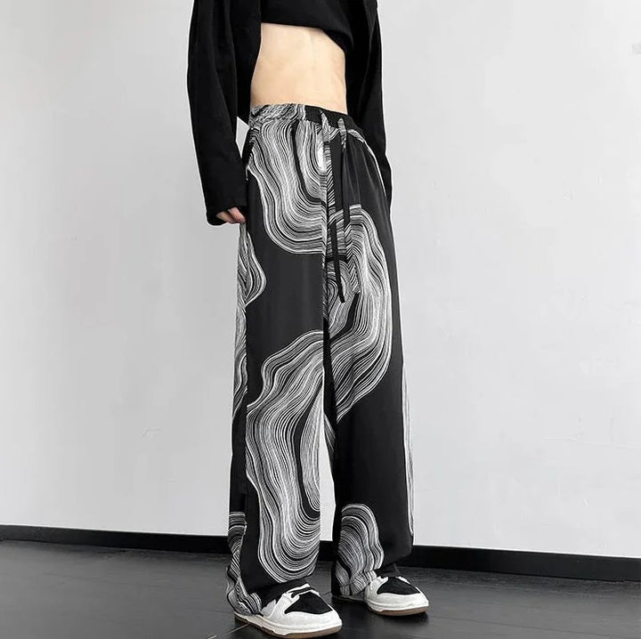 Vortex Ripple Pants featuring a black and white abstract print, wide-leg style, and adjustable drawstring waist.