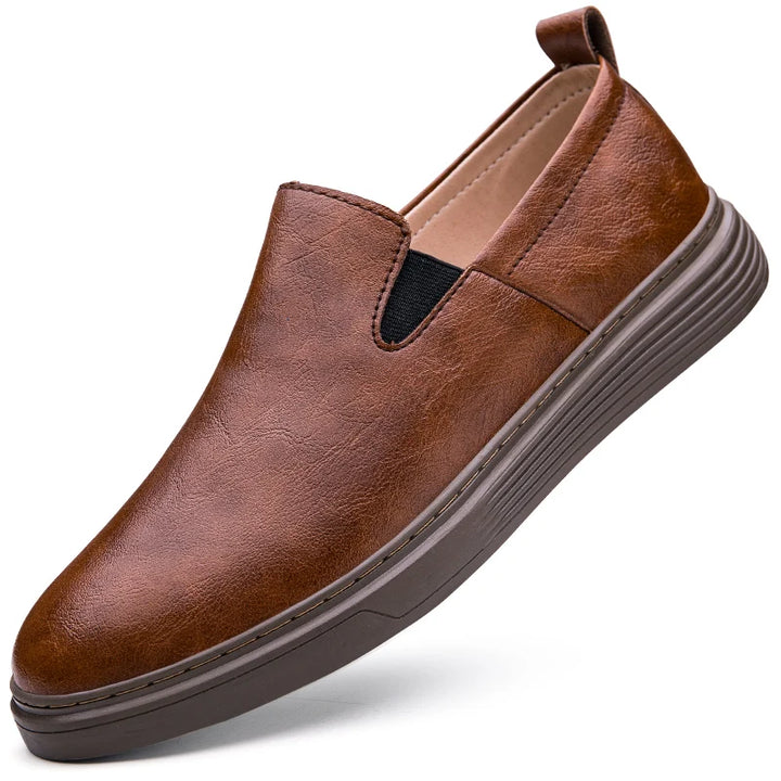 Duke Leather Slip-On Shoes in brown, featuring genuine leather, cushioned sole, and elastic side panels for easy wear.