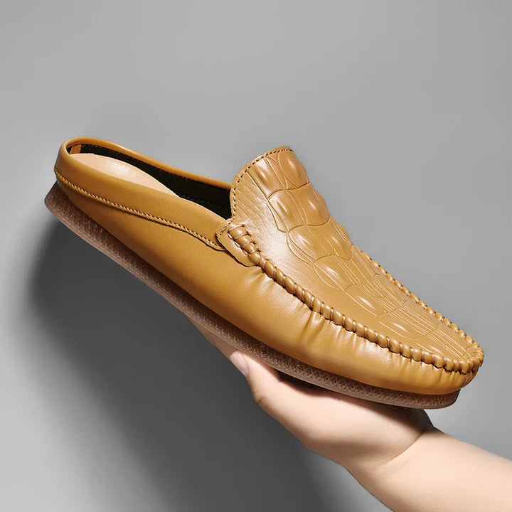 Gianni Backless Slide Loafers in tan with embossed upper and classic moc toe, designed for comfort and style.