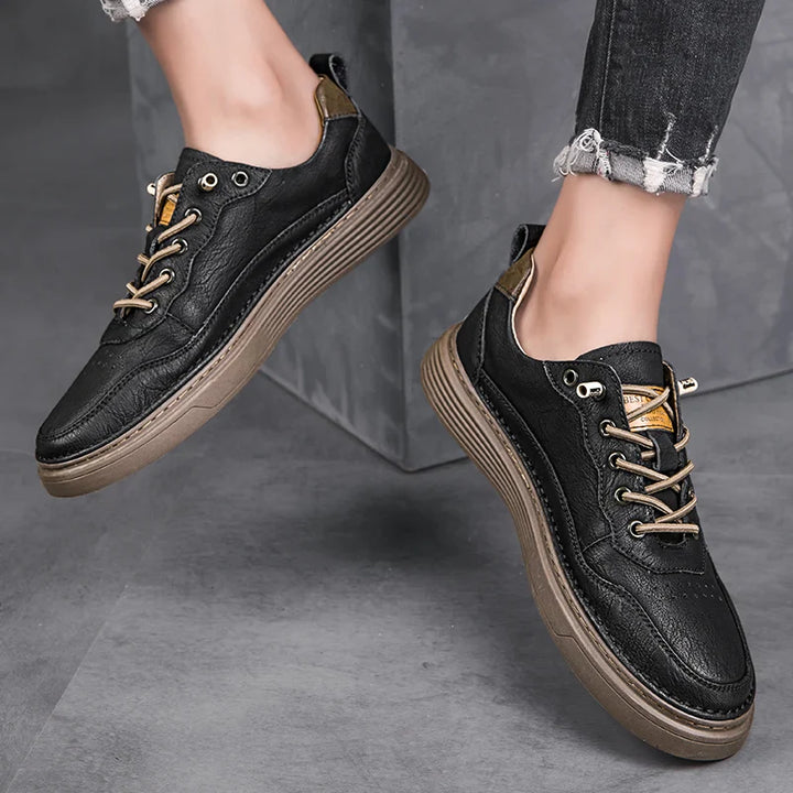 Alvo genuine leather sneakers with artisanal hand-stitched detailing in black and brown, showcasing exceptional comfort.
