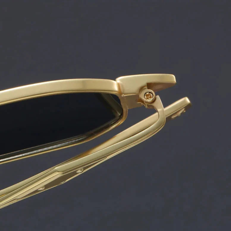 Close-up of Atlas Alloy Sunglasses featuring a gold geometric frame and sculpted metal arms.