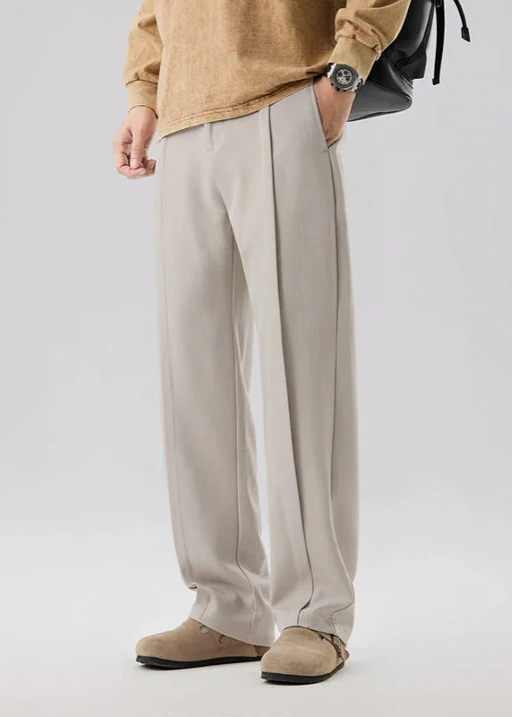Calloway pleated trousers in light grey, featuring a relaxed straight-leg silhouette and breathable fabric.