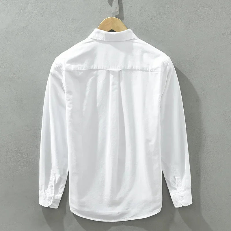 Back view of a white Rowan 100% cotton shirt on a hanger, showcasing clean tailoring and a sleek design.