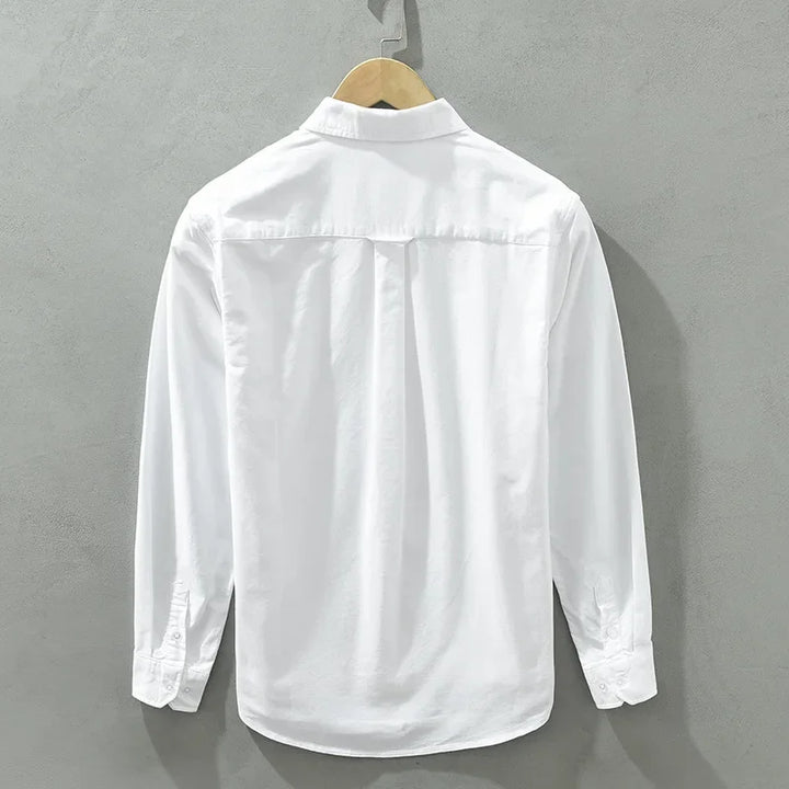 Back view of a white Rowan 100% cotton shirt on a hanger, showcasing clean tailoring and a sleek design.