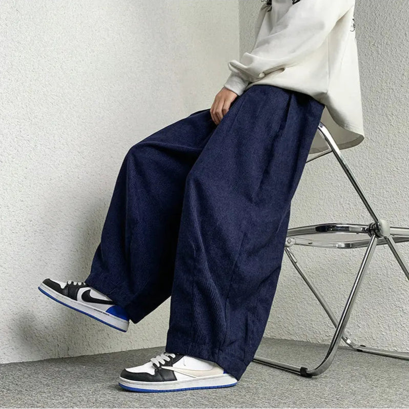 Casual model wearing navy Arlo Corduroy Pants with wide-leg fit, showcasing relaxed style and comfort.