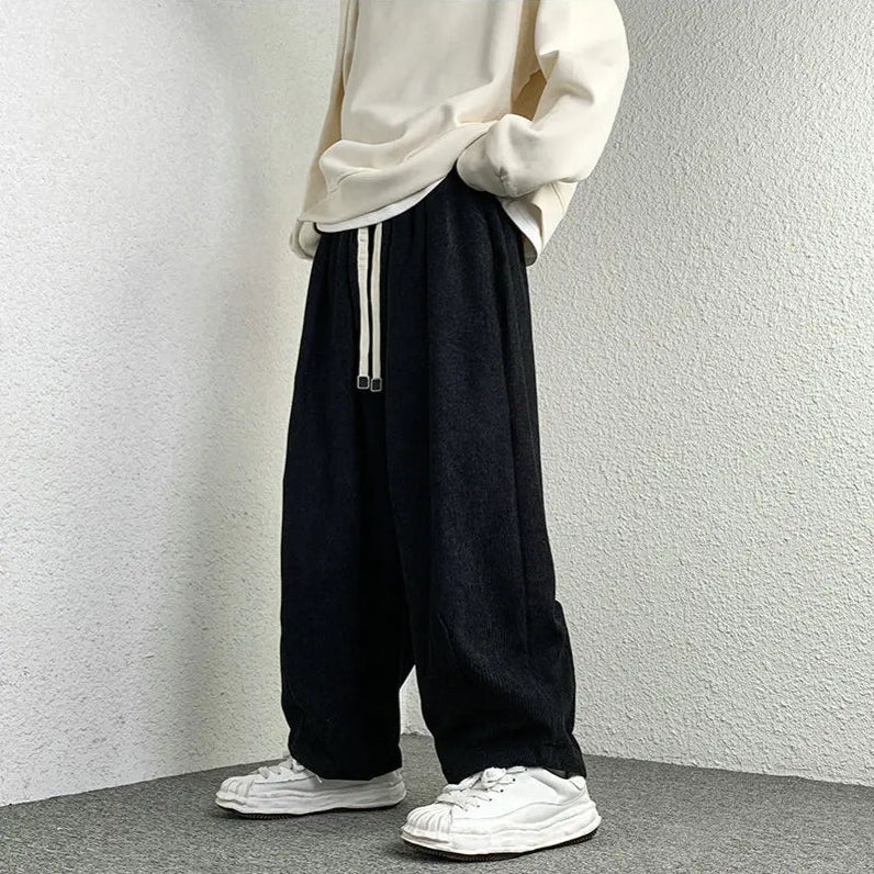 Arlo Corduroy Pants featuring a wide-leg fit, adjustable drawstring waist, and deep pockets, shown with casual footwear.