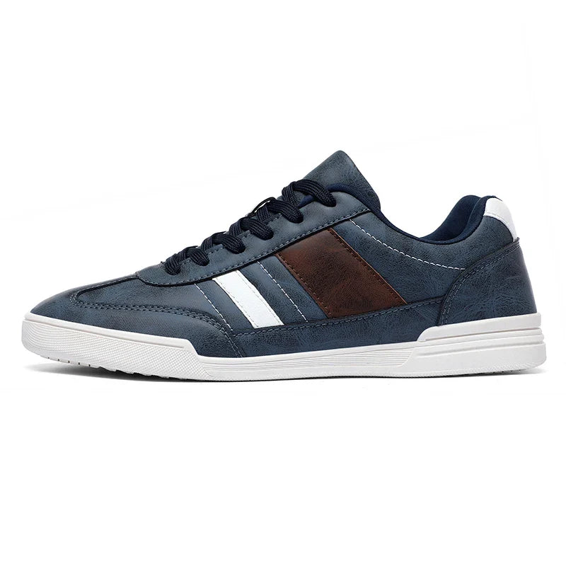 Rival Sport Sneakers in navy blue with contrast white and brown panels, featuring a sleek low-profile design.