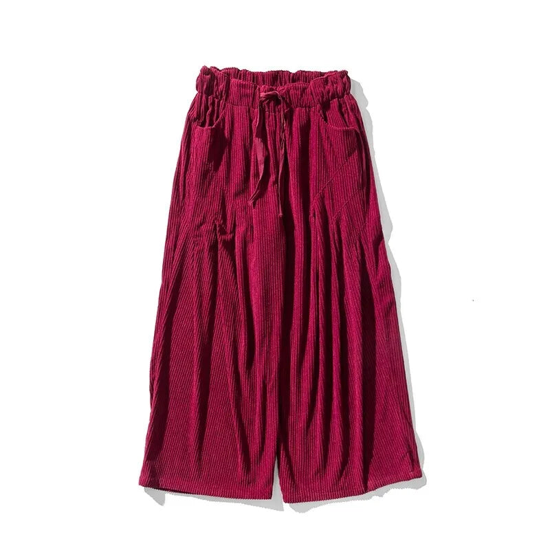 Hollis Corduroy Pants in deep burgundy, featuring wide-leg silhouette, deep pleats, and smooth elastic waistband for comfort.